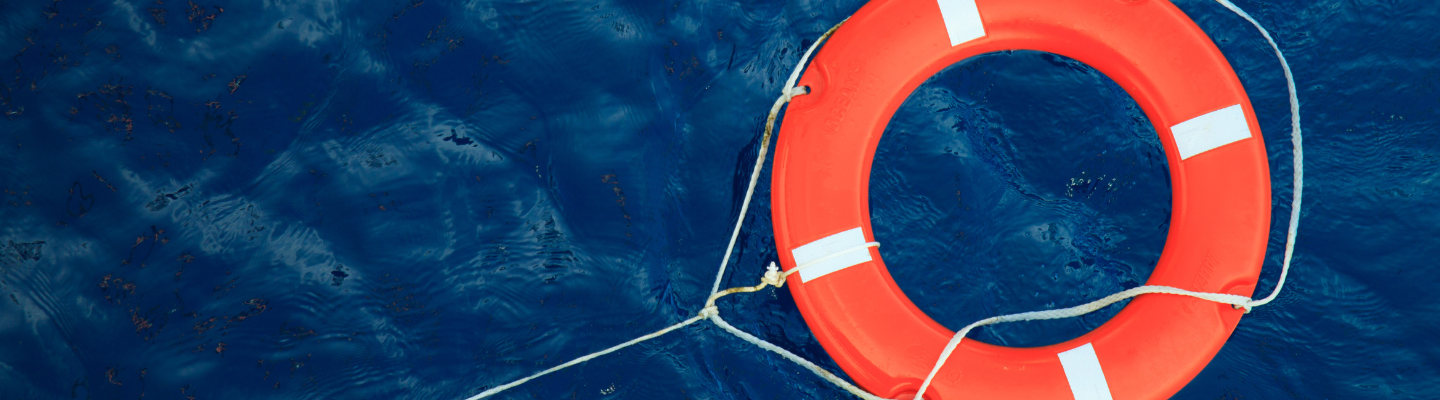 Family In A Little Boat With Life Jackets on