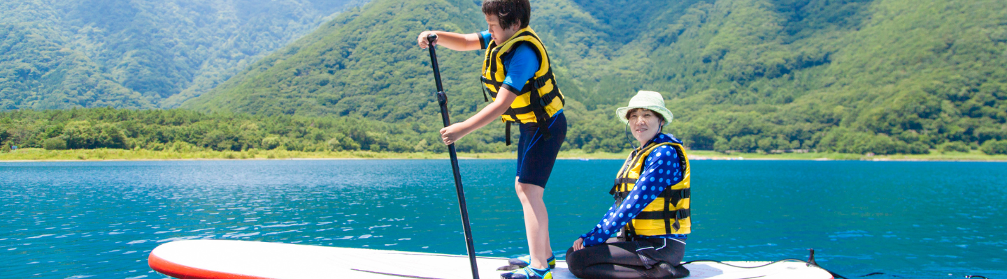 Woman and Kid on paddle board 