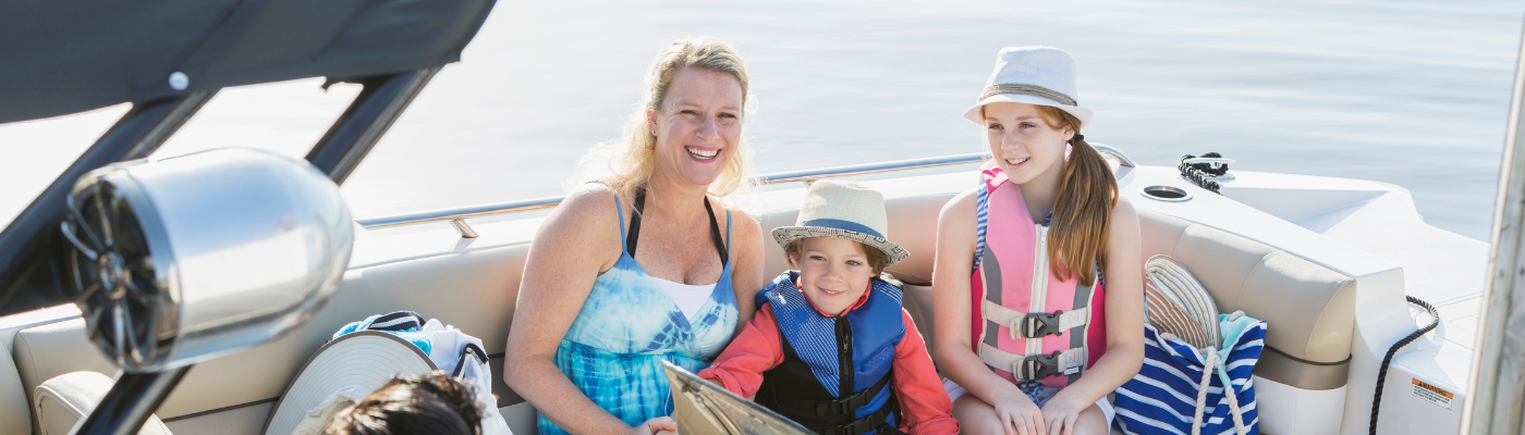 a family on a boat with life jackets