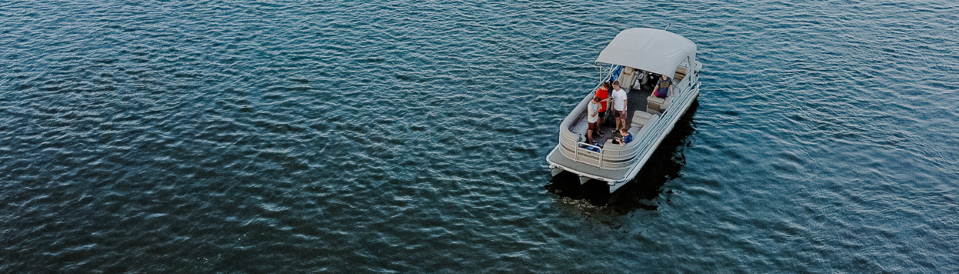 pontoon boat in the middle of a lake