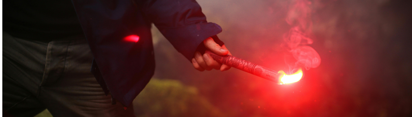 a person holding an emergency flare