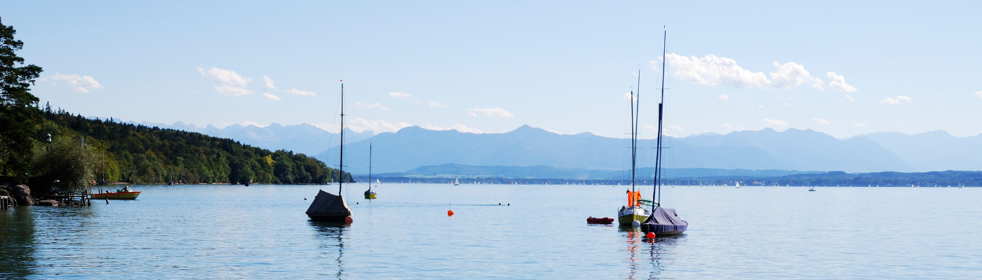 a lake with multiple sailboats